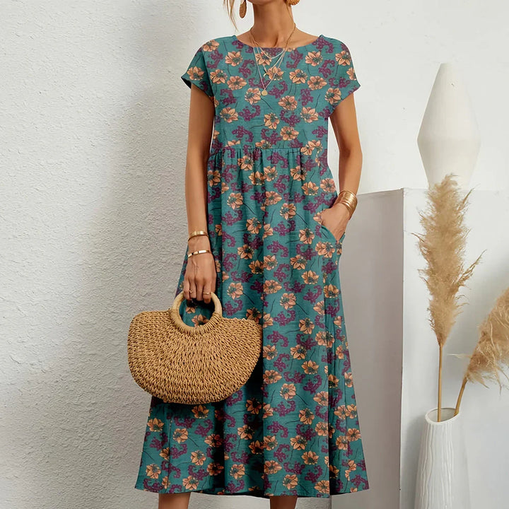 Versatile women's midi dress. Features round neck, cap sleeves, relaxed fit. Great casual spring/summer style.