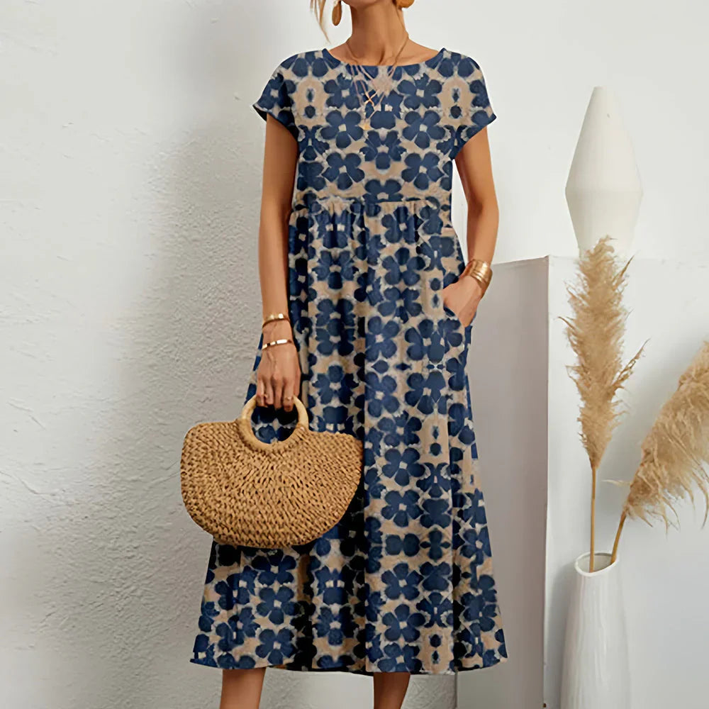 Comfortable women's relaxed fit midi dress for summer and spring. Features cap sleeves and round neck.