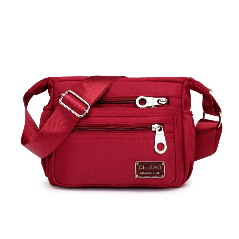 Women's casual nylon crossbody bag styled over a jacket, showcasing its adaptability