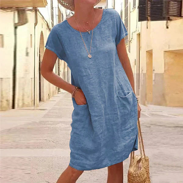 Relaxed fit women's short sleeve midi dress featuring practical pockets, great for comfortable everyday summer wear.
