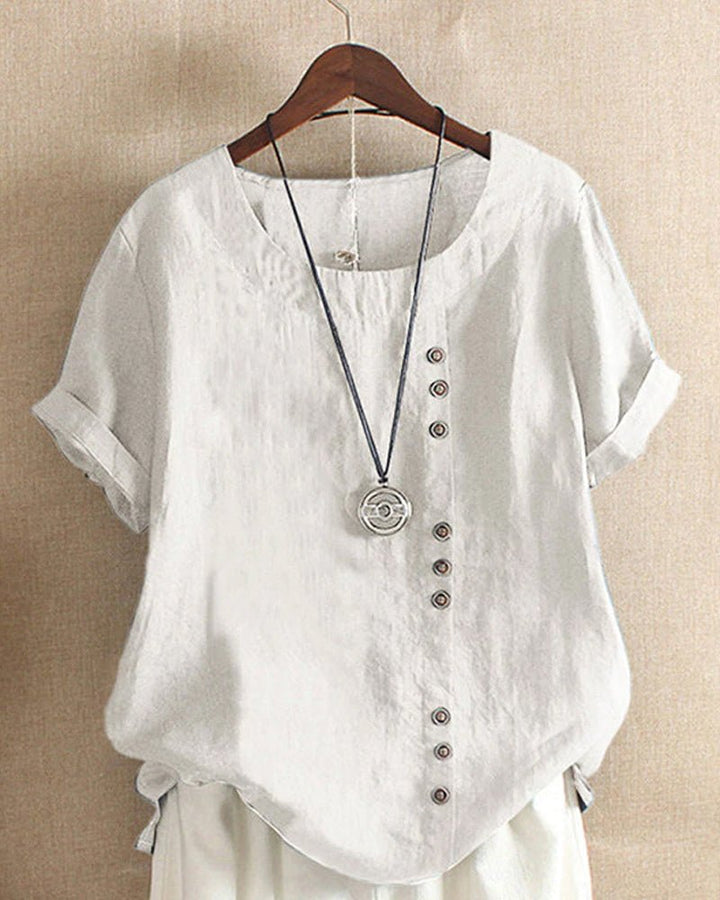 Relaxed fit women's short sleeve top, featuring a stylish button front. Ideal for versatile casual spring & summer outfits.