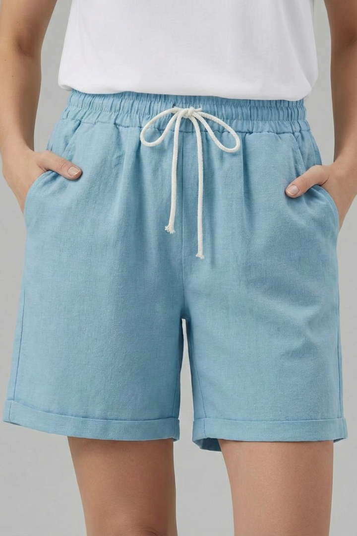 Folded women's casual shorts with elastic waist, drawstring, and cuffed hem, ready for summer adventures.
