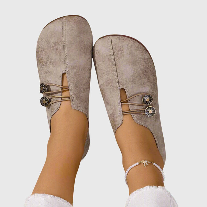 Lightweight slip-on women's flats with unique button detail, ideal for comfortable casual wear