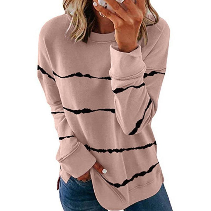 Model wearing a women's striped long sleeve pullover sweatshirt, showcasing relaxed fit and style