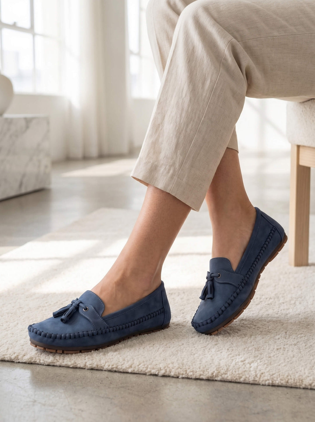 Close-up of a women's tassel loafer, showcasing the detailed stitching and soft material for comfort.