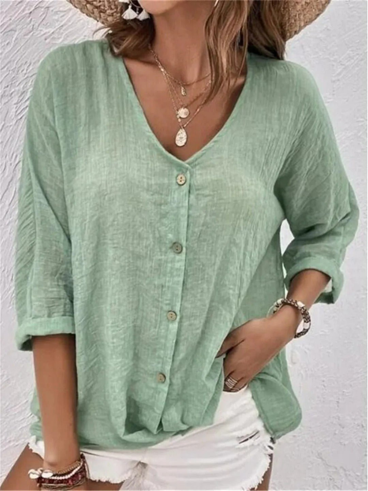 Women's casual V-neck button-front top, three-quarter sleeves. Comfortable, relaxed fit for everyday style.