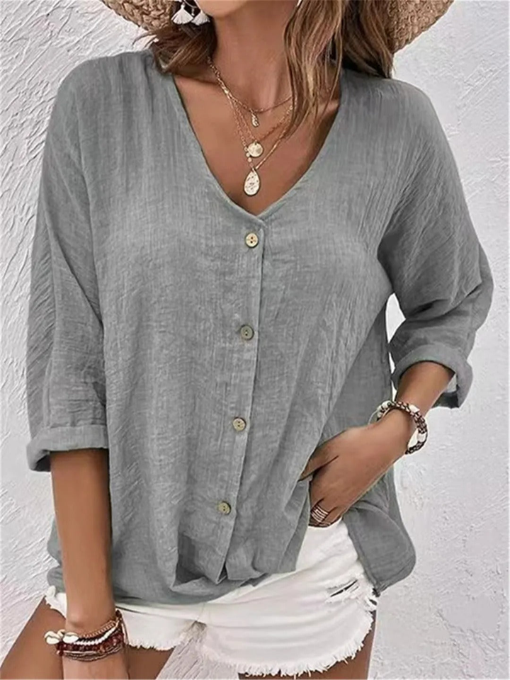Comfortable women's V-neck shirt with button-front design. Relaxed fit, three-quarter sleeves for effortless everyday style.