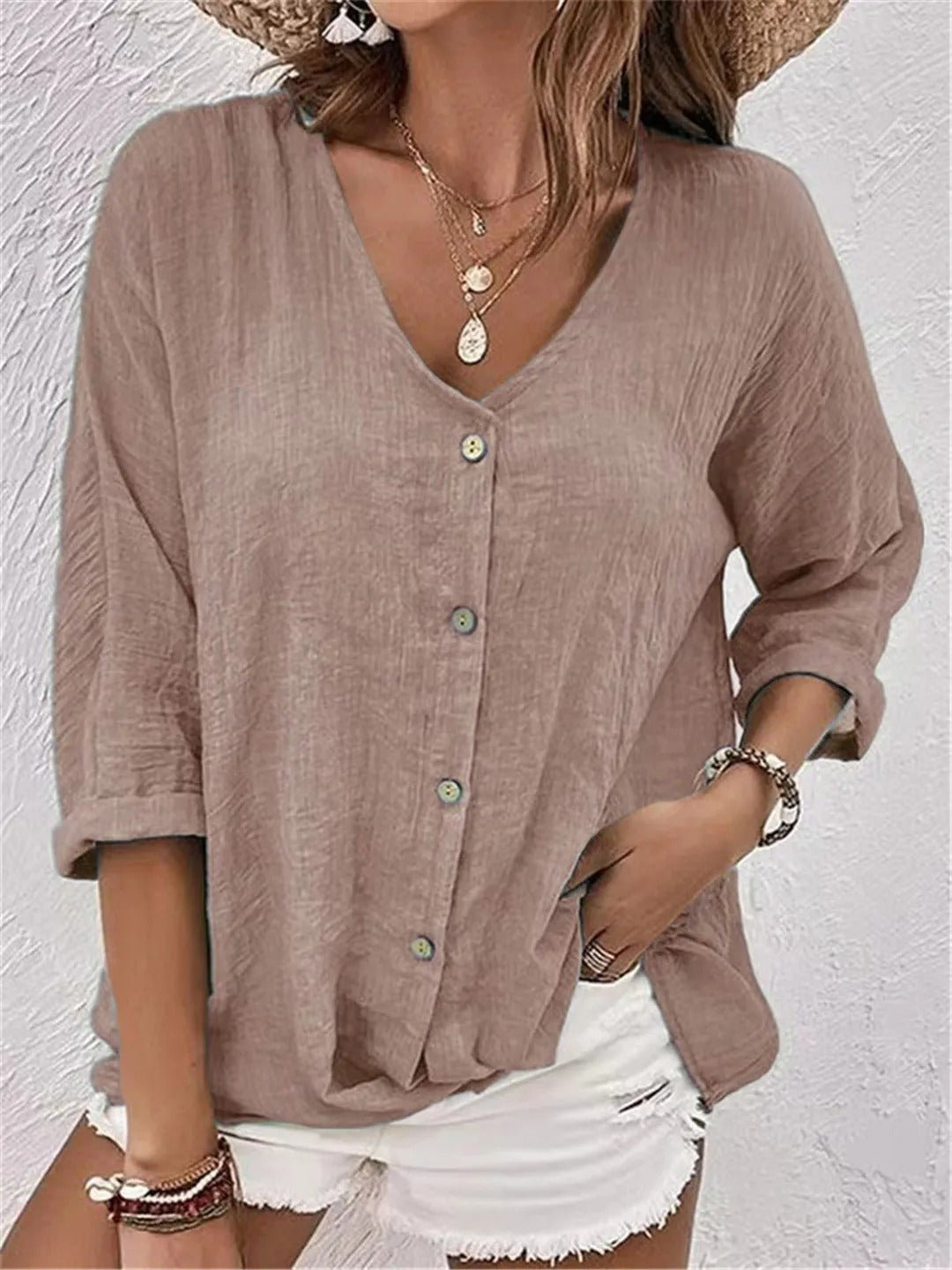 Soft, comfortable women's casual V-neck top. Features button front and three-quarter sleeves for effortless spring style.