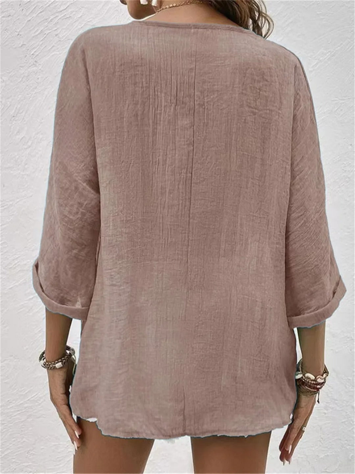 Women's relaxed V-neck button-front top with three-quarter sleeves. Great for casual spring/summer everyday wear.