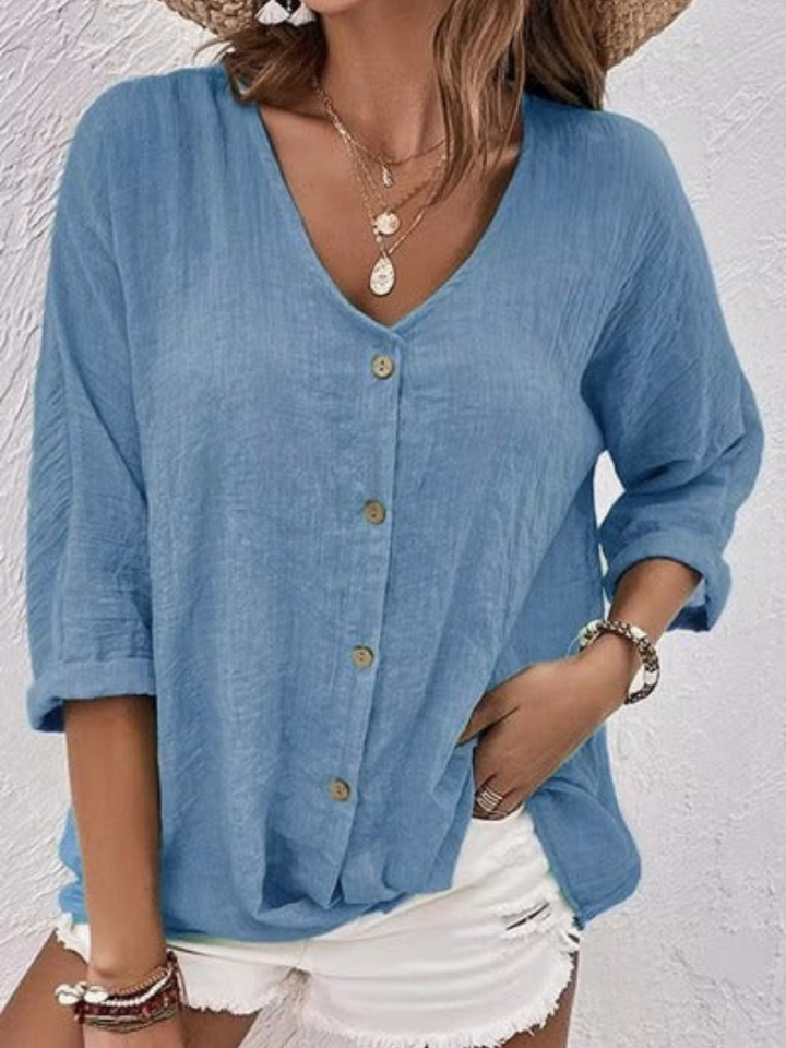 Effortless casual women's V-neck top. Solid color, button-front, three-quarter sleeves for comfort and style.