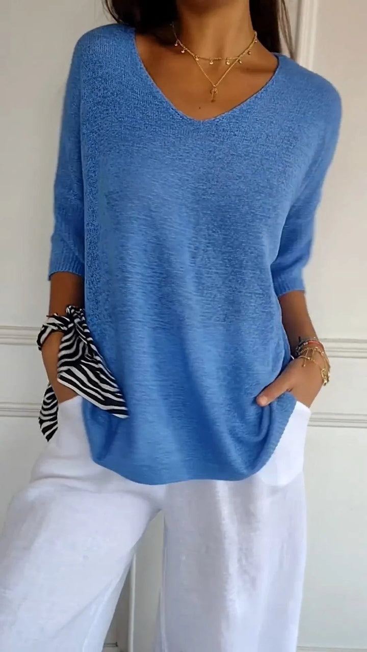 Relaxed fit women's V-neck pullover with three-quarter sleeves, offering ultimate comfort and style.