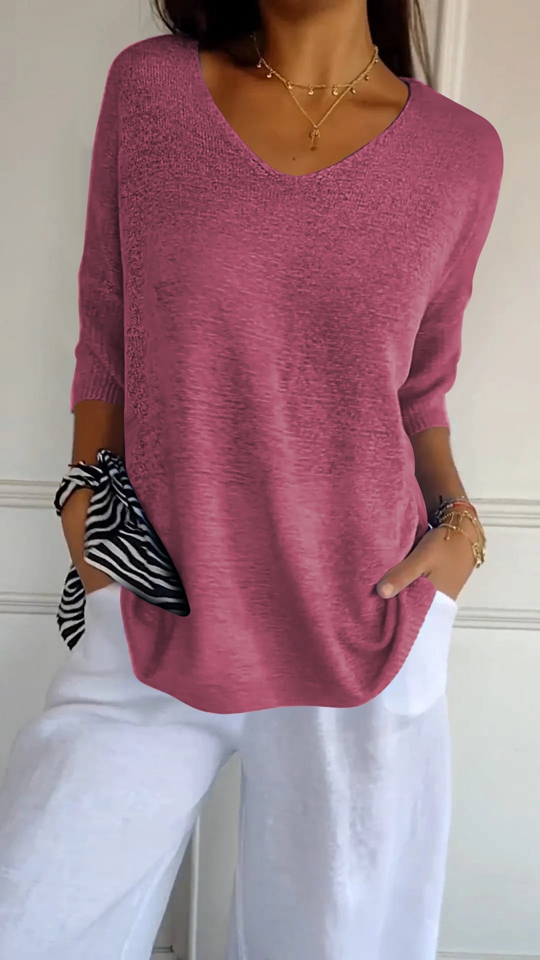 Stylish V-neck women's pullover top, a comfortable loose-fit design with three-quarter sleeves.