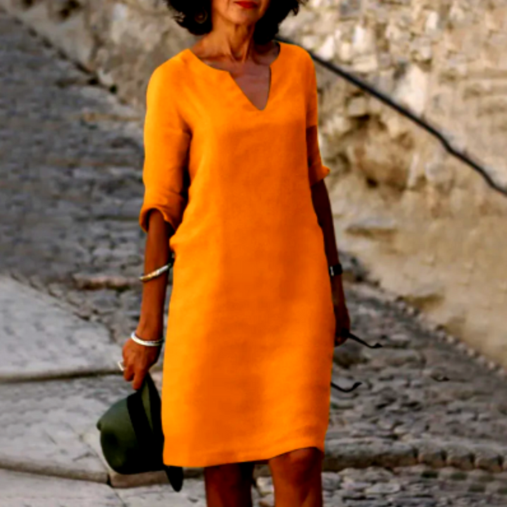 Breathable women's summer shift dress, V-neck, half sleeves, relaxed fit for warm days.
