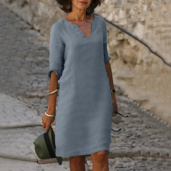 Relaxed fit women's casual shift dress with V-neck & half sleeves for summer comfort.