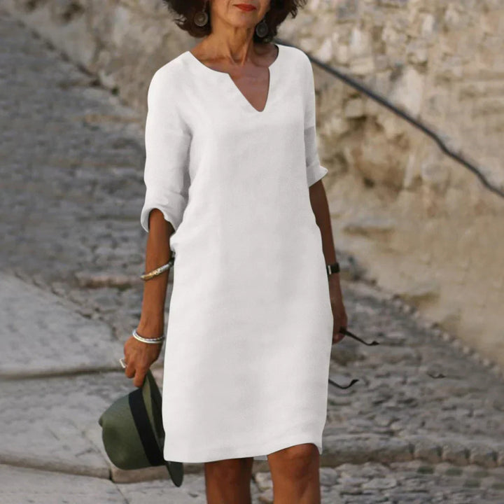 Woman wearing a relaxed fit V-neck shift dress with half sleeves for summer casual outings.