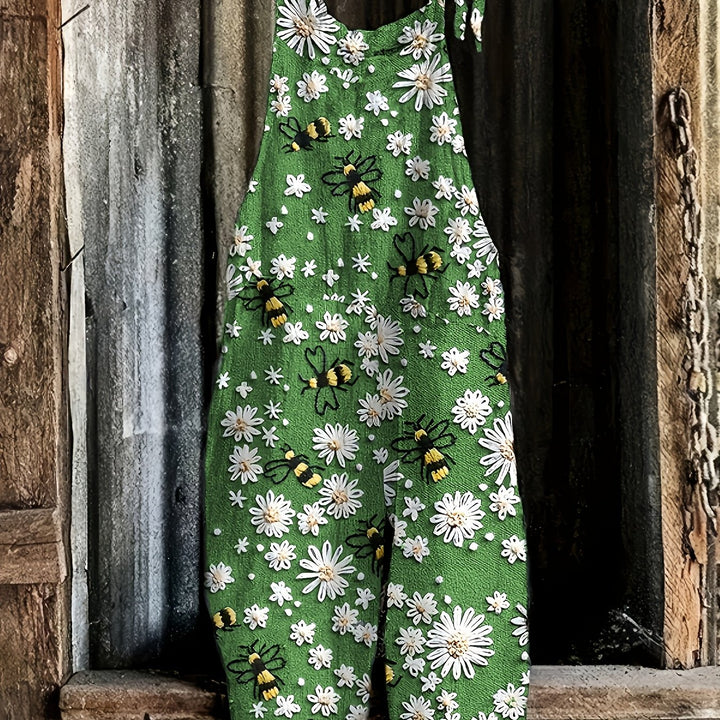 Woman wearing a comfortable daisy & bee print casual jumpsuit with pockets, enjoying a summer day.