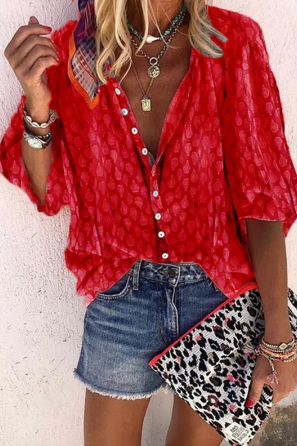 Close-up of the lightweight, airy fabric and delicate buttons on this versatile women's long-sleeve blouse.