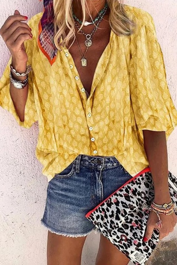 Side view of a woman in a long-sleeve, relaxed-fit airy blouse, showcasing its lightweight design for spring.