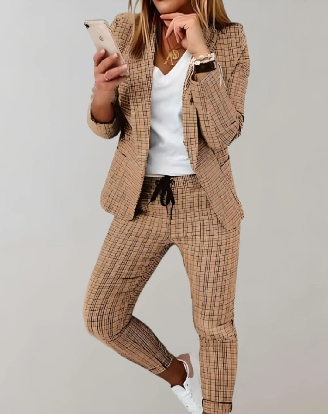 Beautiful women's spring fashion set featuring a stylish blazer and comfortable matching trousers.