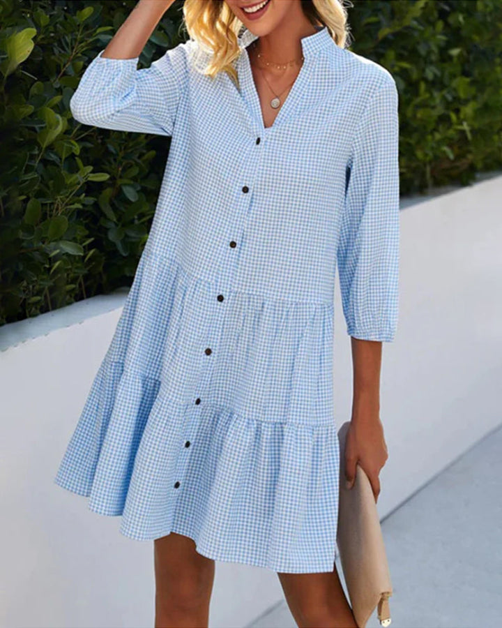 Relaxed fit women's blue checkered summer midi dress with short sleeves and a practical button front design.