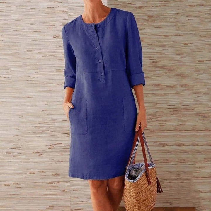 Women's chic button-front shift dress, knee-length, with convenient side pockets, perfect for casual summer wear.