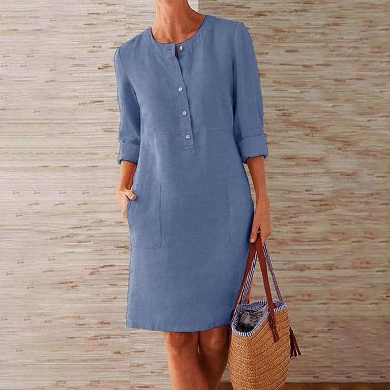 Comfortable women's shift dress featuring a button-front, 3/4 sleeves, and practical pockets for everyday style.