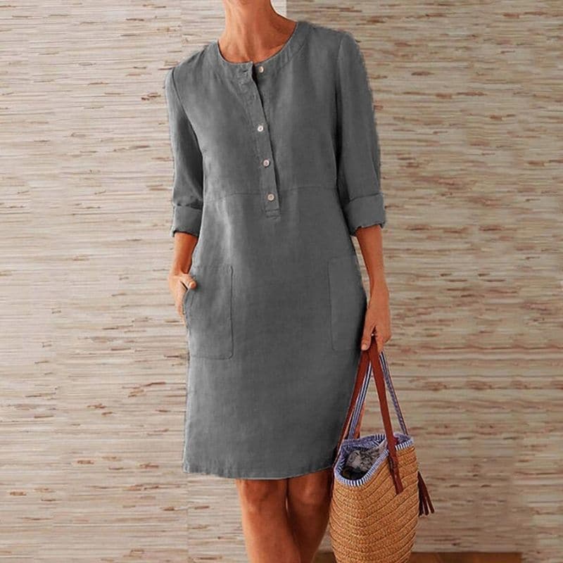 Casual knee-length women's shift dress with button-front closure, 3/4 sleeves, and handy pockets for summer.