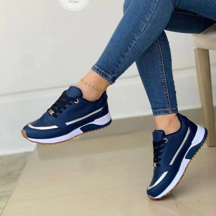 Stylish women's platform sneakers, featuring gold trim & lace-up design; versatile casual footwear for fashion.