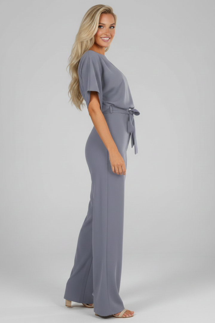 Modern women's round neck, short sleeve jumpsuit with elegant waist tie, ideal for spring and summer fashion.