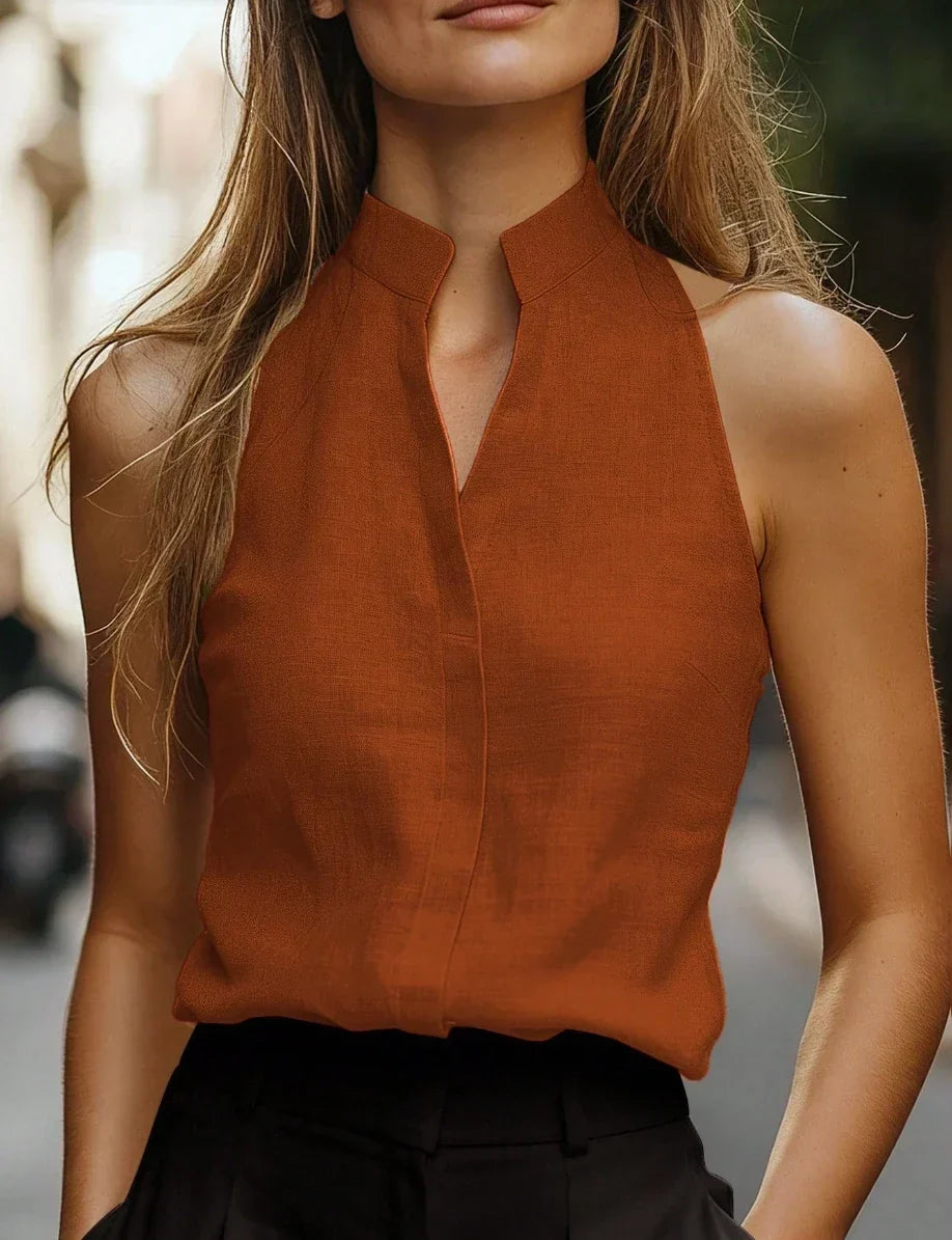 Women's chic sleeveless mock neck blouse for effortless summer style; perfect for casual or office wear. Relaxed fit.
