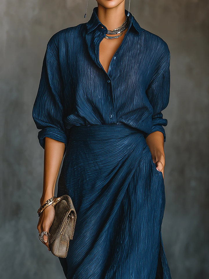 Coordinated women's fashion set: long sleeve wrap top with collared v-neck and matching high-waist maxi skirt.