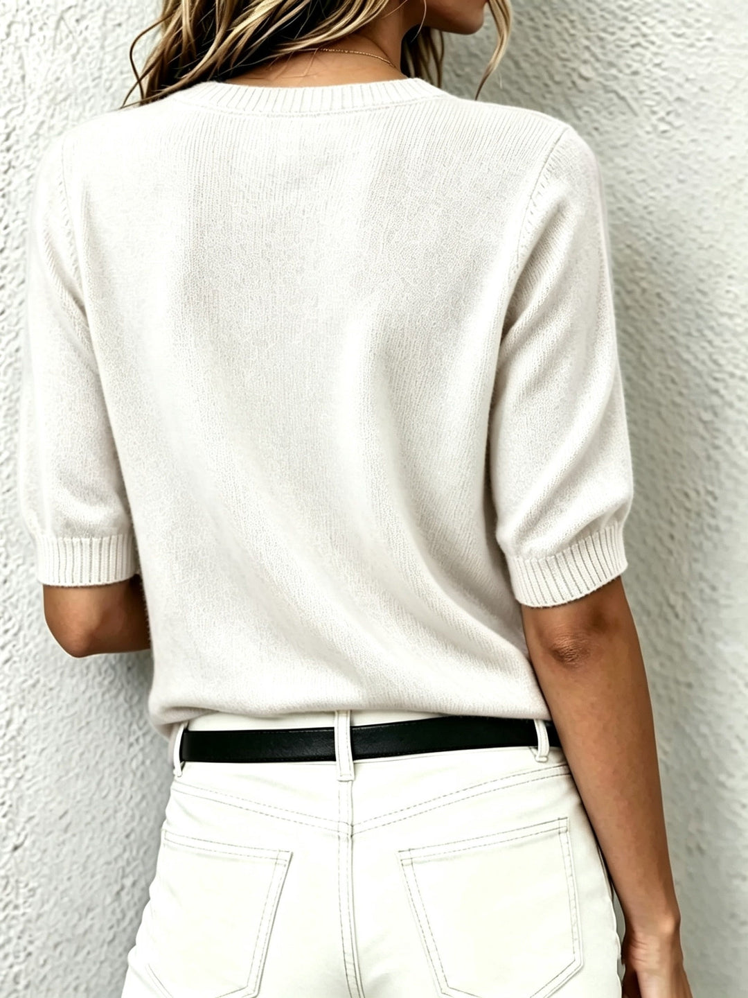 Modern women's V-neck short-sleeve top, ideal for transitional fashion, offering versatile office and everyday wear.