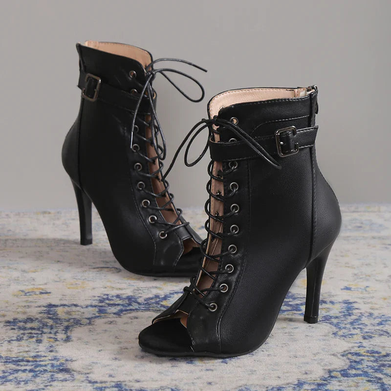 Black stiletto heels with an ankle strap and seductive lace-up front, perfect for women's nights out.