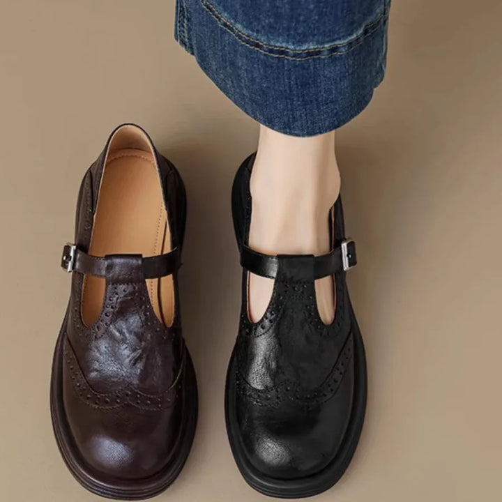 Women's classic black leather T-strap flats, vintage-inspired design for everyday wear.