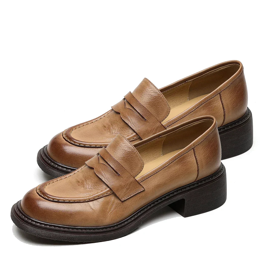 Close-up of women's leather T-strap flat shoes in classic brown, showcasing quality and style