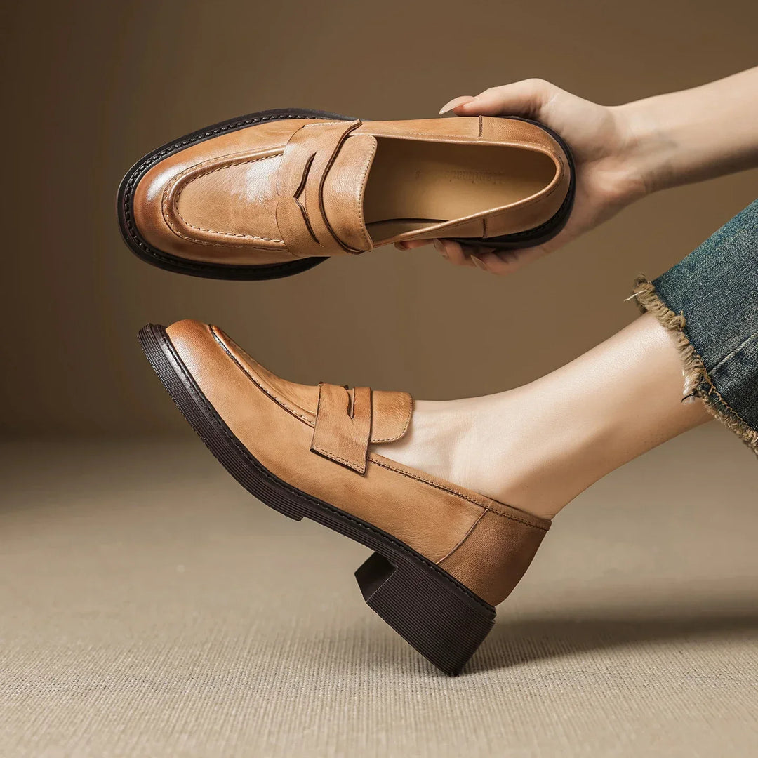 Stylish women's brown leather T-strap flats, perfect for elegant and comfortable everyday wear