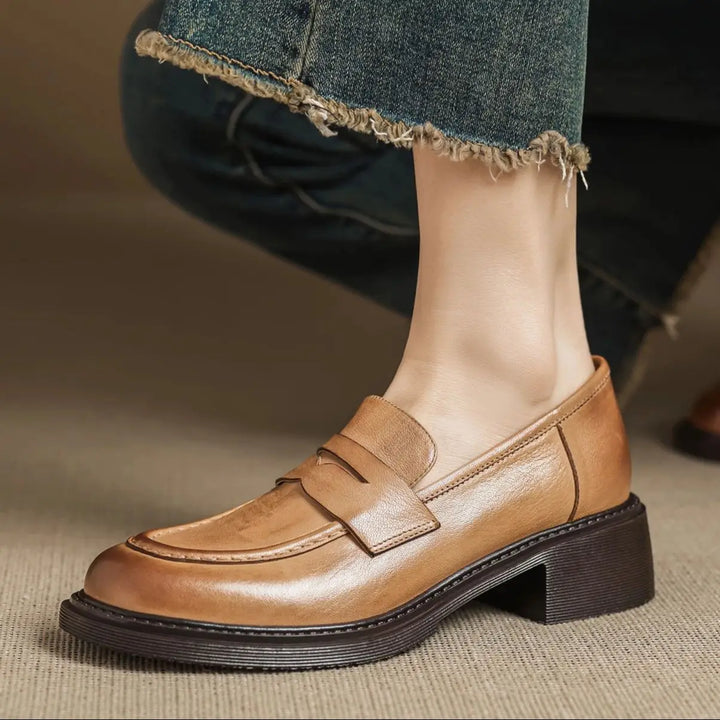 Side view of women's elegant brown leather T-strap flat shoes, providing classic and comfortable fit