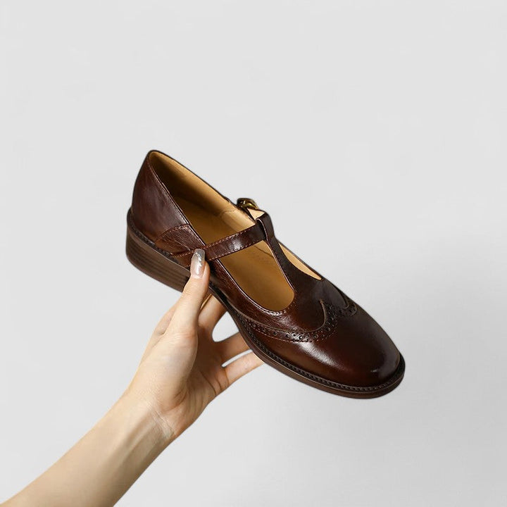 Close-up of the smooth black leather and classic design of women's buckle strap Mary Janes