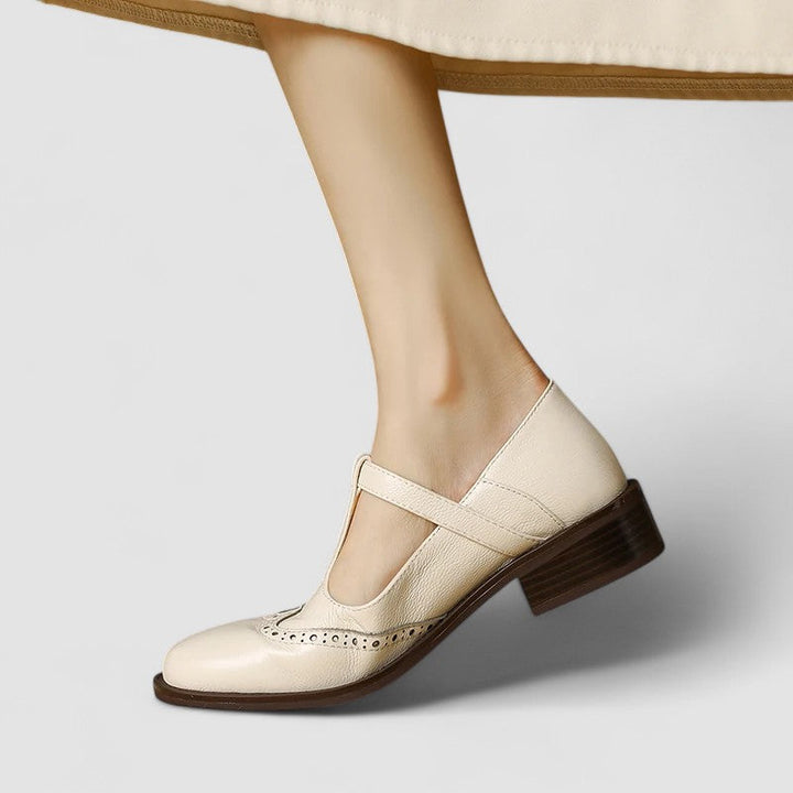 Side view of a women's flat Mary Jane shoe with an adjustable buckle strap, classic and versatile