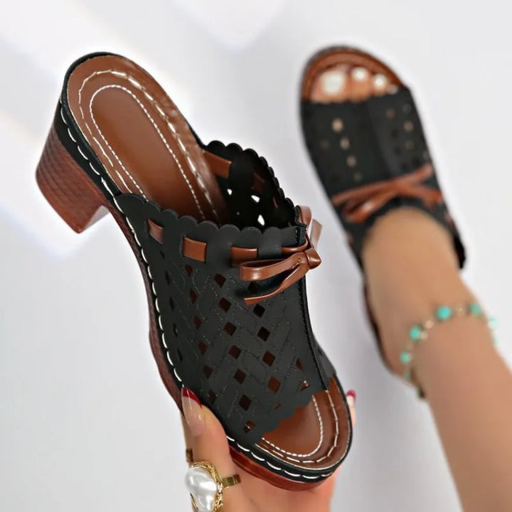 Fashionable women's mules with a unique cutout pattern and sturdy block heel for comfort.