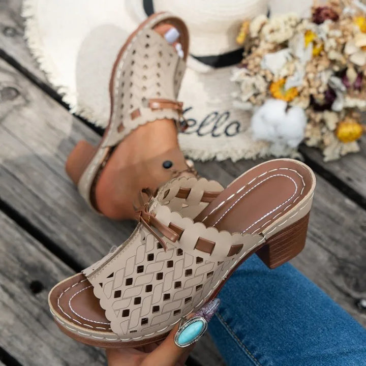 Scalloped cutout block heel mules for women, combining classic style with modern comfort.