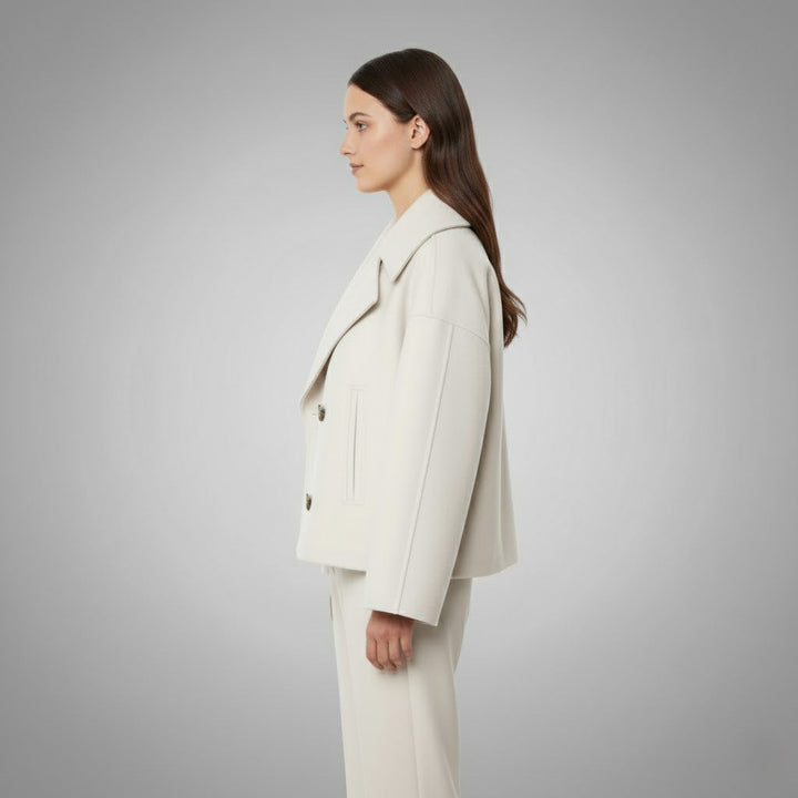 Elegant women's short jacket with prominent double buttons, tailored fit, versatile fashion piece.