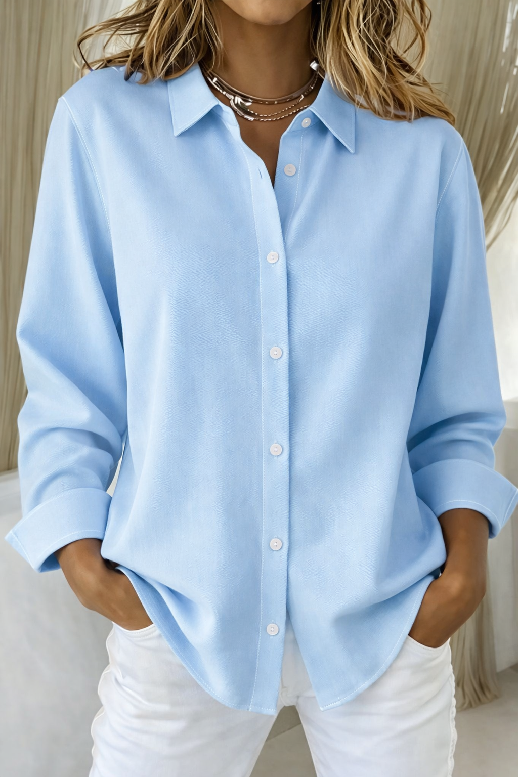 Elegant women's classic long sleeve button-up blouse. Relaxed fit design offers timeless style for all occasions.