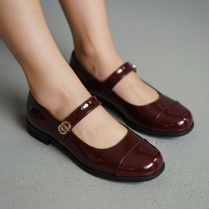 Elegant women's Mary Jane flats with patent sheen & ergonomic comfort.