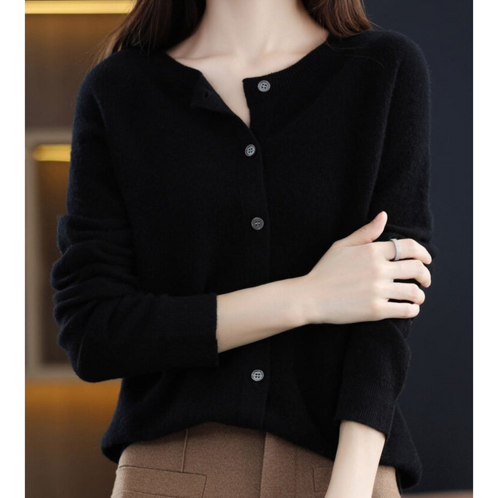 Women's crew neck merino wool sweater, ideal for winter, with subtle button accents on front.