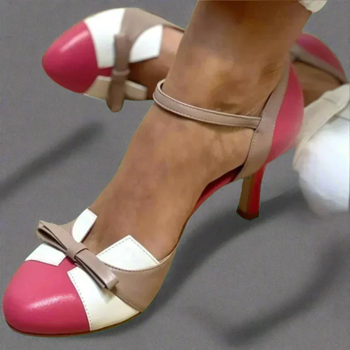 Elegant women's mid-heel pumps featuring a stylish bow strap. Ideal for occasion wear, formal shoes, & comfort.