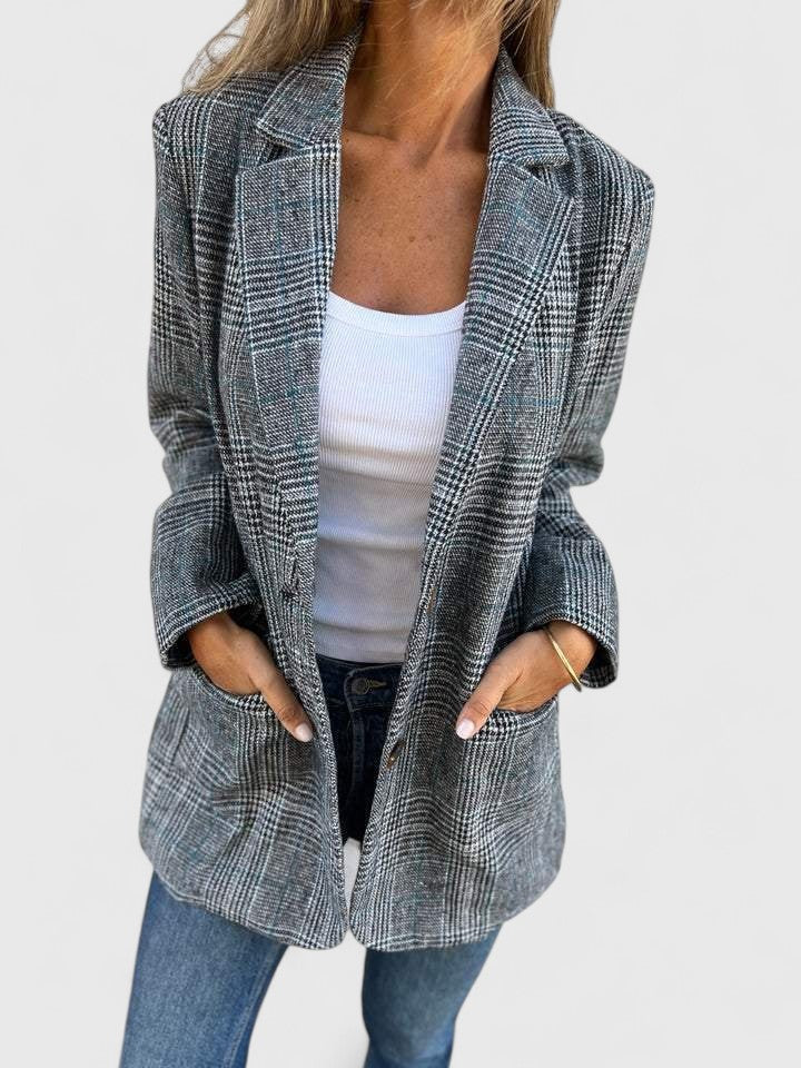 Oversized women's plaid blazer with a relaxed boyfriend fit, ideal for a classic, modern fashion statement.