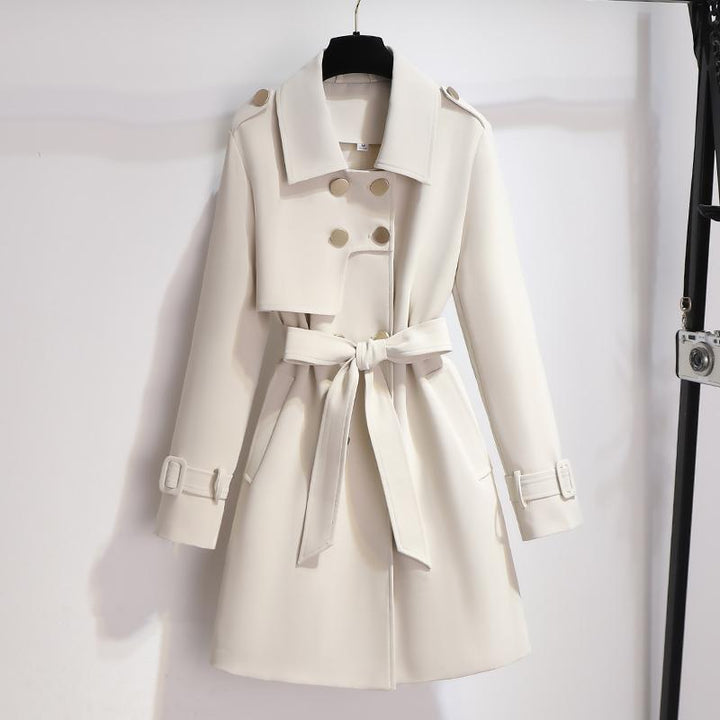 Women's classic white belted trench coat with wide lapels, perfect for sophisticated outerwear fashion