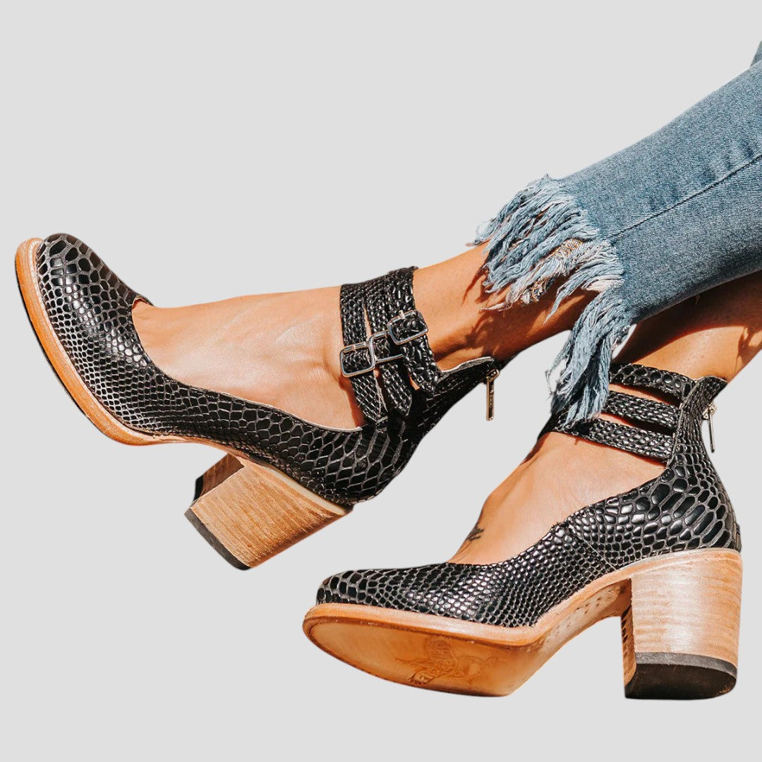 Sturdy women's block heels featuring a chic closed toe and secure buckle strap for comfort & style.