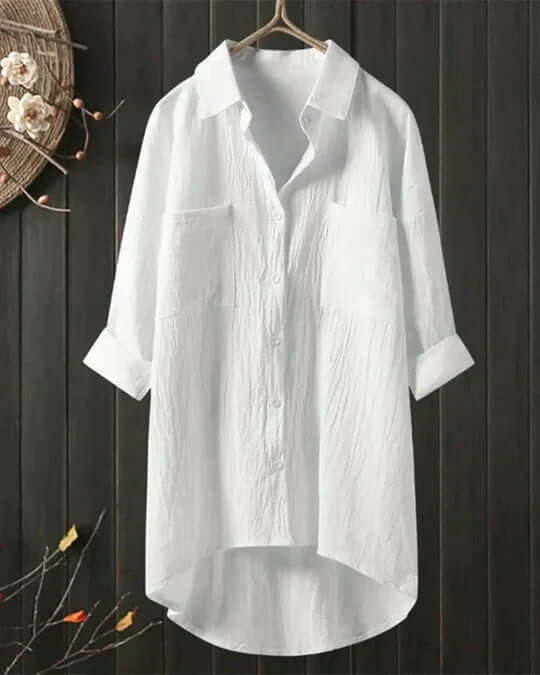 Women's collared double pocket longline blouse with roll tab sleeves, offering a relaxed oversized fit.
